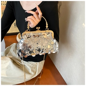 Detail of silver sequin evening bag with gold metal handle and chain strap for women