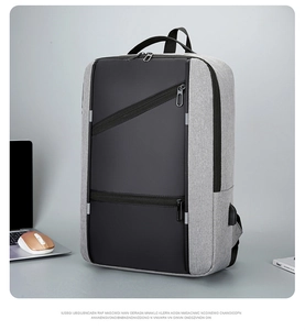 Detail of business backpack featuring USB charging port and zipper pockets in office setting