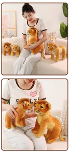 Detailed view of plush lion cub toys in various sizes and poses with soft spotted fur