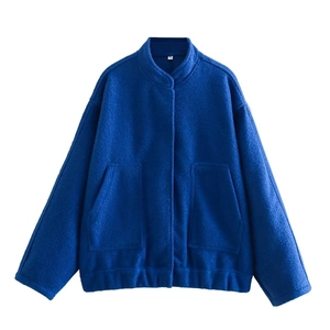 Detail of Klein blue cropped jacket with tweed texture, high collar and large pockets