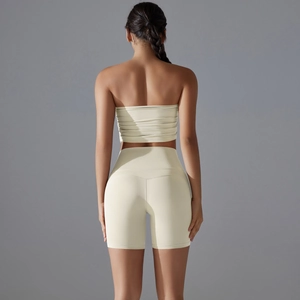 Back view of light yellow seamless sports set with tube top and high waist biker shorts