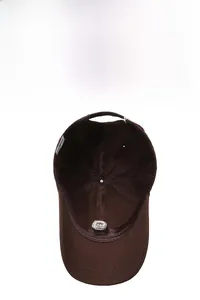 Detail view of dark brown baseball cap interior with sweatband and breathable vent holes