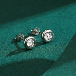 Elegant S925 sterling silver round stud earrings with clear cubic zirconia on green background