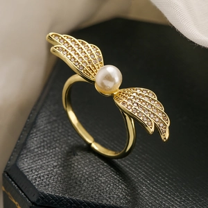 Adjustable gold plated wing ring with a center pearl and sparkling zircon accents