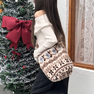 Winter plush bucket bag with festive snowflake pattern shown in a holiday setting