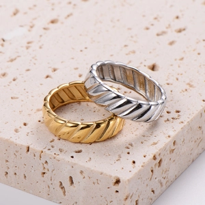 18K gold and silver stainless steel rings with a minimalist twisted tire pattern design