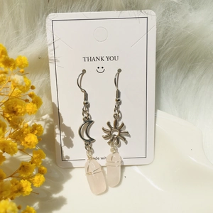 Handmade sun and moon stainless steel earrings with wire-wrapped rose quartz crystals