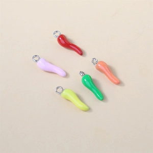 Macro view of five colorful enamel chili pendants for DIY jewelry earrings and necklaces