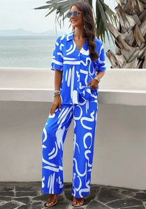 Detailed view of women's two-piece blue short-sleeve shirt and matching trousers