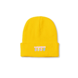 Detailed knit texture of bright yellow beanie with cute cartoon bear print and text