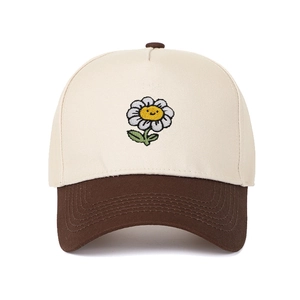Close-up of smile sunflower embroidery on bicolor beige and brown cotton baseball cap
