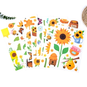 Close-up of double-sided spring window clings with sunflowers, bees and butterfly motifs