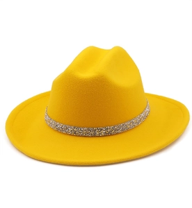 Detailed shot of yellow wool fedora hat featuring a sparkling silver glitter decorative band