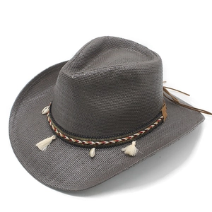 Close-up of dark grey straw cowboy hat with ethnic beads, shells and tassel trim