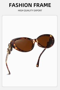 Detail of tortoise cat eye sunglasses with brown lenses and golden star temple rivets