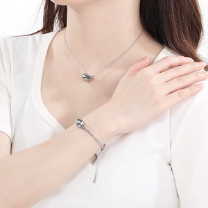 Detailed view of silver stainless steel drop necklace and adjustable ball bracelet set