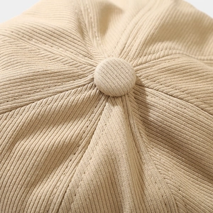 Retro khaki octagonal newsboy hat showing top button detail and twill fabric texture