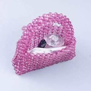 Macro detail of purple beaded woven handbag showing interior space and acrylic beads texture