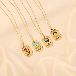 Set of 4 gold tarot card pendant necklaces featuring The Lovers, Sun, Tower, and Moon