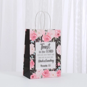 Detail of pink rose floral paper gift bag with Proverbs 3:5 quote and white rope handles