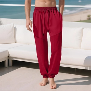 Red men's joggers with waffle texture stitching and drawstring waist on patio