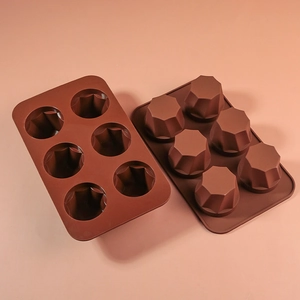 Detail of 6-cavity brown silicone mold with geometric star shapes for baking and ice