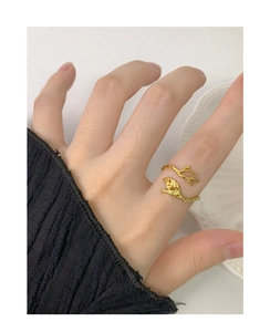 Detail of leaf and branch design S925 sterling silver open ring in golden finish