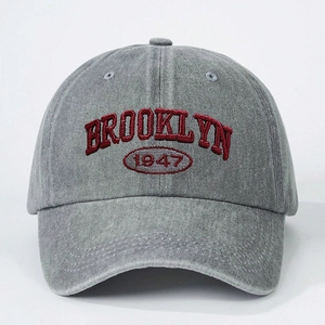 Close-up of vintage washed grey cotton baseball cap with red Brooklyn 1947 embroidery