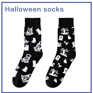 Detail of Halloween socks featuring skull cat and graveyard knitted patterns