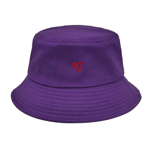 Detailed view of red heart embroidery on a purple cotton bucket hat with parallel stitching