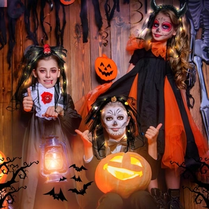 Detail view of Halloween costumes for kids including witch and skull bride dresses