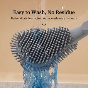 Silicone toilet brush head in grey under running water showing easy cleaning effect