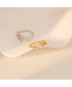 Detailed macro view of vine-shaped rings with sparkling crystals in gold and silver