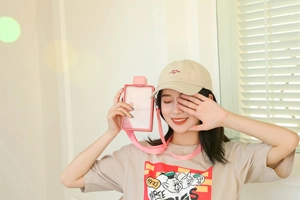 Close-up of pink square plastic water bottle with adjustable cartoon graphic strap