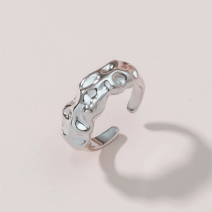 Adjustable silver brass ring featuring an irregular textured molten lava surface design