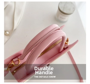 Detail of pink PU leather handbag showing high-quality stitching and gold hardware