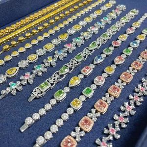 Detailed view of various colorful zircon bracelets with heart and teardrop shapes
