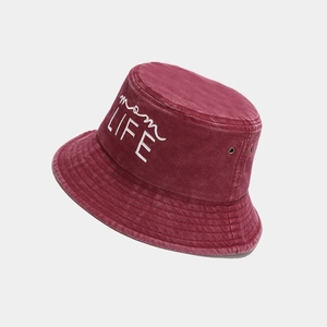Macro view of white mom LIFE embroidery on vintage washed burgundy cotton bucket hat