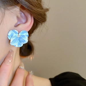 Elegant blue flower stud earrings with matte resin petals and a small sparkling crystal
