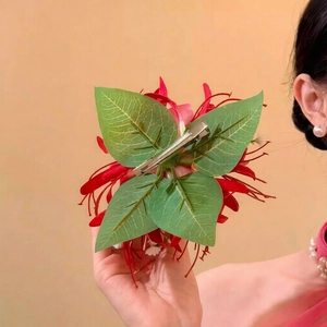 Detail showing the silver metal duckbill clip back of this elegant fabric flower hair pin