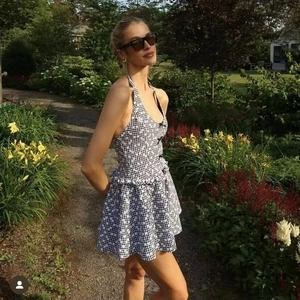 Sweet black and white plaid halter dress with backless design and ruffled hemline