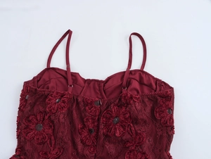 Close-up of wine red lace slip dress featuring floral sequins and intricate embroidery