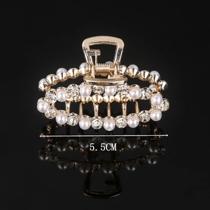 Detail view of a 5.5CM gold hair claw clip with elegant pearls and sparkling rhinestones