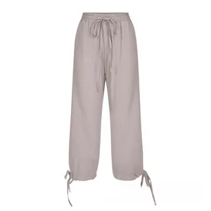 Close-up of gray cotton linen pants featuring elastic drawstring waist and adjustable cuffs