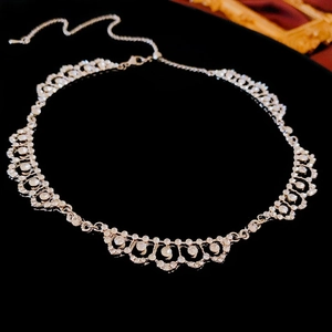 Lace style geometric necklace with sparkling diamonds on a black reflective surface