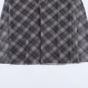 Close-up of black and grey plaid mesh fabric texture on the asymmetrical skirt