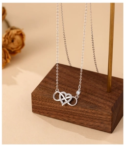 Detail of 925 sterling silver heart infinity necklace with cubic zirconia stones
