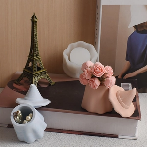 Detail view of wavy ghost jar silicone molds with finished plaster storage containers