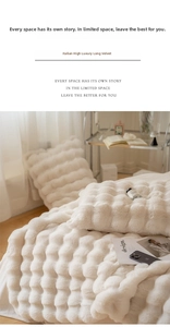 Close-up of cream faux fur blanket featuring 3D bubble texture and shaggy texture
