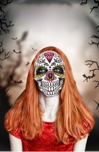 Detail of Halloween sugar skull mask with red diamond pattern and floral decorations